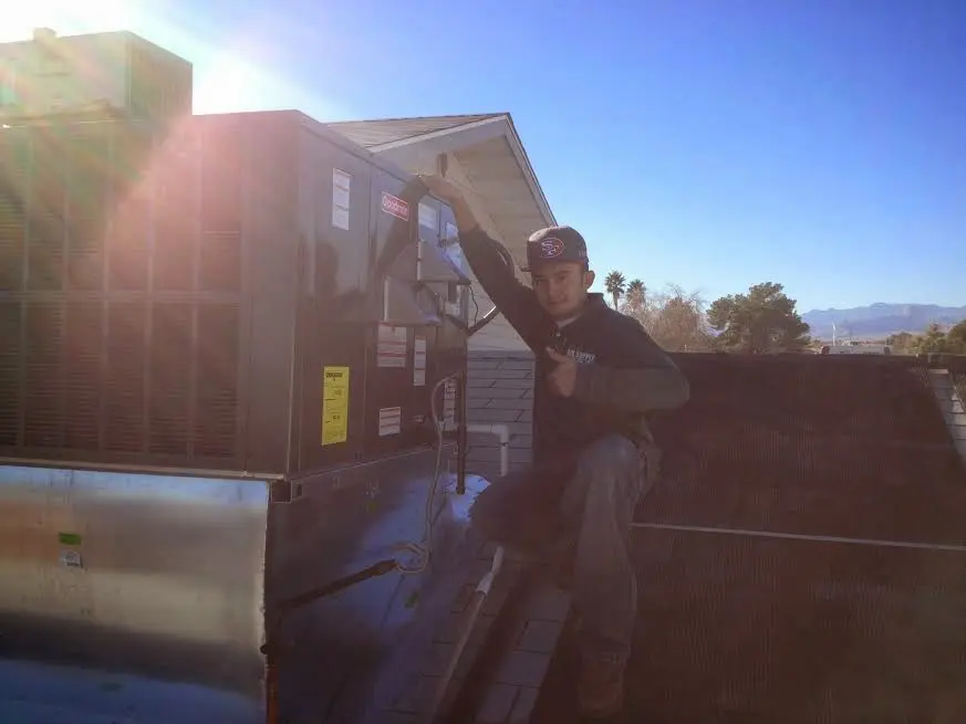 HVAC technician performing HVAC Inspection on a rooftop unit in Richfield